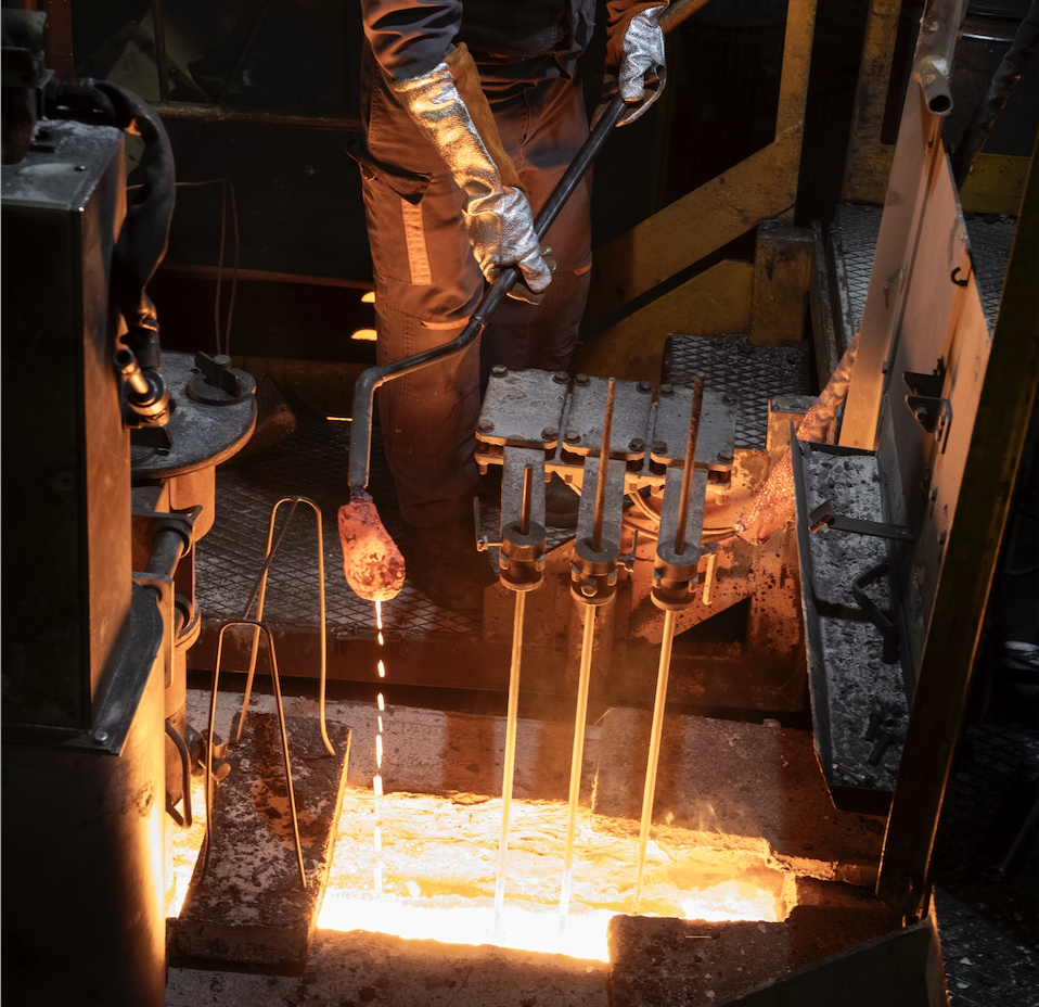 Cast iron molten being poured in the Le Creuset factory Cast iron molten being poured in the Le Creuset factory